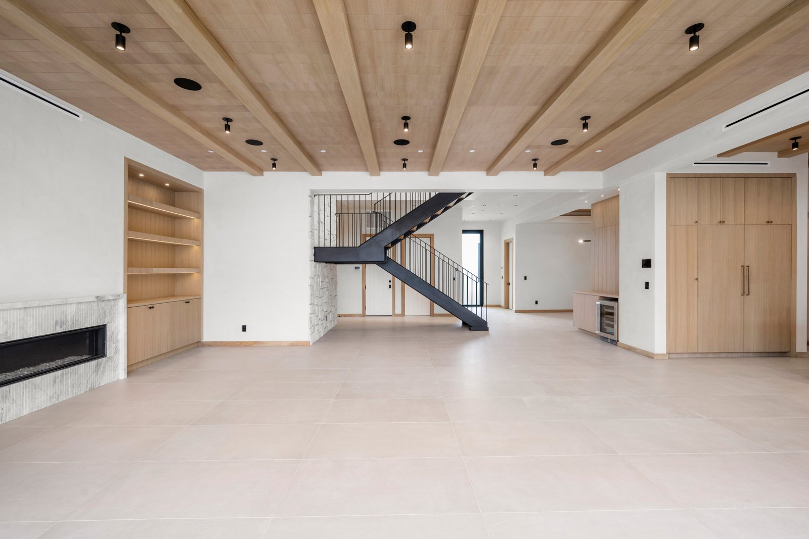 Empty living room with fireplace and wooden ceiling